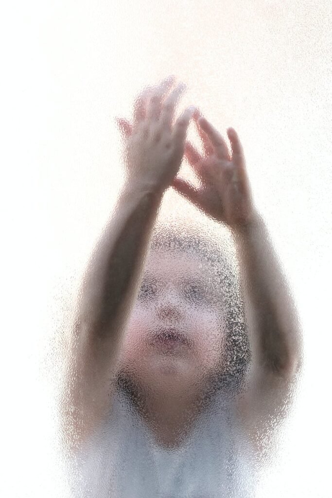little child behind a glass